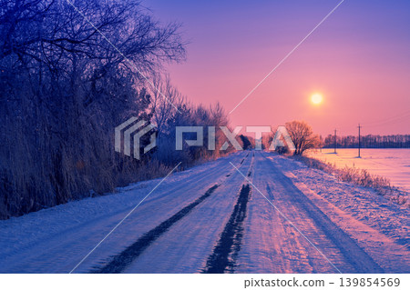 Early morning, road covered with snow at sunrise Early morning, road covered with snow at sunrise 139854569