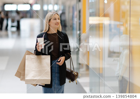 Woman enjoying retail therapy and window shopping at mall 139854804