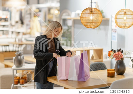 Young woman taking selfie in a modern furniture store Young woman taking selfie in a modern furniture store 139854815