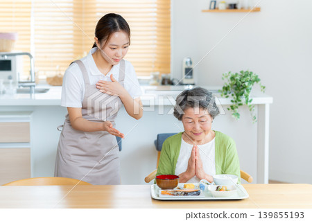 A caregiver and a senior woman preparing a meal A caregiver and a senior woman preparing a meal 139855193