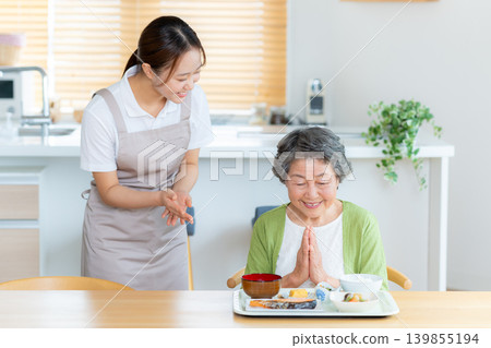 A caregiver and a senior woman preparing a meal A caregiver and a senior woman preparing a meal 139855194