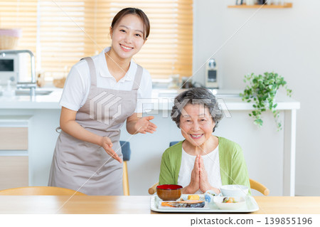 A caregiver and a senior woman preparing a meal A caregiver and a senior woman preparing a meal 139855196