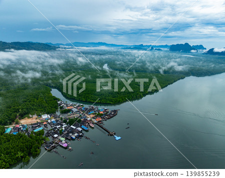 Aerial view top view of the fisherman village with fishing boats and house roof at the pier in Phang Nga Thailand Aerial view top view of the fisherman village with fishing boats and house roof at the pier in Phang Nga Thailand 139855239