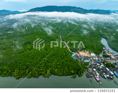 Aerial view top view of the fisherman village with fishing boats and house roof at the pier in Phang Nga Thailand 139855241