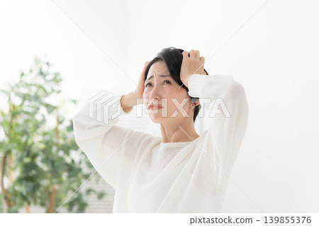 A woman holding a head A woman holding a head 139855376