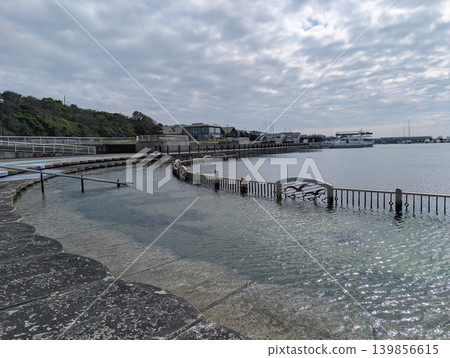 A fence submerged in the seashore of Hokkaido, and a tranquil seascape. A fence submerged in the seashore of Hokkaido, and a tranquil seascape. 139856615