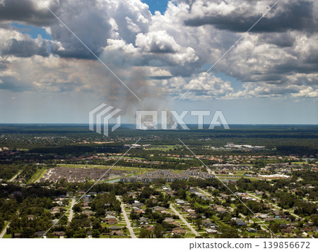 Prescribed fire spreading through dry grassland near Florida town as part of forest management. Prescribed fire spreading through dry grassland near Florida town as part of forest management. 139856672