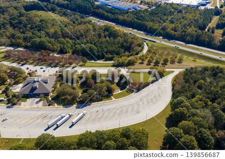 Roadside parking area for cars and trucks on multilane interstate highway, serving as convenient stop for travelers on long drives. Roadside parking area for cars and trucks on multilane interstate highway, serving as convenient stop for travelers on long drives. 139856687