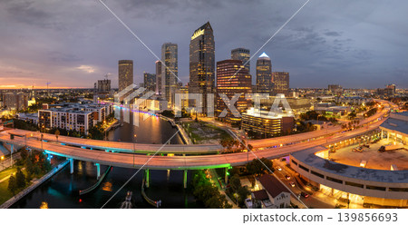 Tampa, Florida. Cars traffic driving on highway bridge and high skyscraper buildings in downtown district. American city with business financial district at nightfall. 139856693