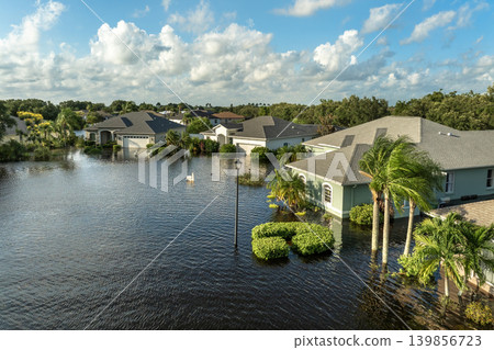 Flooding in Florida caused by tropical storm from hurricane rainfall. Suburb houses in residential community surrounded by flood waters. Aftermath of natural disaster 139856723