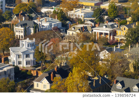 Historical American city architecture. Macon, old city in Bibb County, Georgia. Streets and Victorian houses surrounded by yellow fall trees. Historical American city architecture. Macon, old city in Bibb County, Georgia. Streets and Victorian houses surrounded by yellow fall trees. 139856724