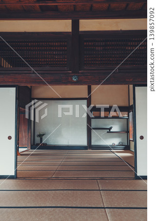 A tranquil Japanese-style room where sliding doors, tatami mats, and an alcove harmonize, exuding the traditional beauty of Japan. A tranquil Japanese-style room where sliding doors, tatami mats, and an alcove harmonize, exuding the traditional beauty of Japan. 139857092