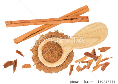 Cinnamon powder in wooden spoon and stick isolated on white background. Top view. Flat lay. Cinnamon powder in wooden spoon and stick isolated on white background. Top view. Flat lay. 139857114