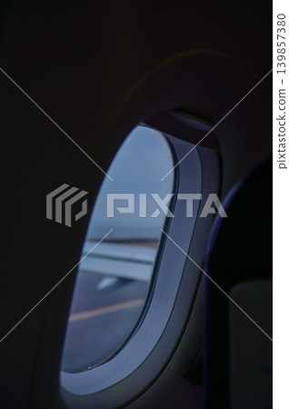 Looking from the airplane window with stunning skyscapes and landscape with airplane wing. Travel and transportation concept. Looking from the airplane window with stunning skyscapes and landscape with airplane wing. Travel and transportation concept. 139857380