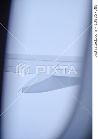 Looking from the airplane window with stunning skyscapes and landscape with airplane wing. Travel and transportation concept. Looking from the airplane window with stunning skyscapes and landscape with airplane wing. Travel and transportation concept. 139857389