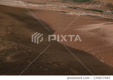 Waves and footprints on the beach (sunset) Waves and footprints on the beach (sunset) 139857465