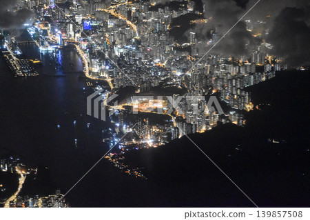 Looking from the airplane window with Hong Kong city night scene. Landing scene. Travel concept. Looking from the airplane window with Hong Kong city night scene. Landing scene. Travel concept. 139857508