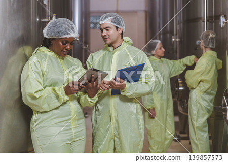 Winemaker working in modern large winery factory liquor drink industry quality. Winemaker working in modern large winery factory liquor drink industry quality. 139857573