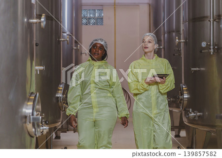 Winemaker working in modern large winery factory liquor drink industry quality. Winemaker working in modern large winery factory liquor drink industry quality. 139857582