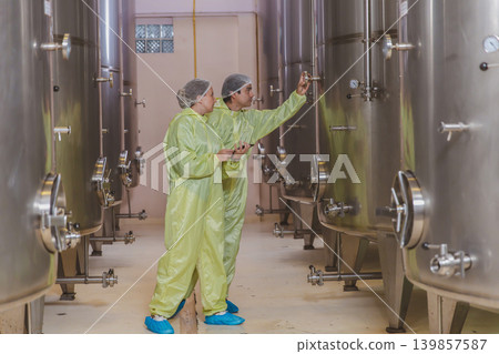 Winemaker working in modern large winery factory liquor drink industry quality. Winemaker working in modern large winery factory liquor drink industry quality. 139857587