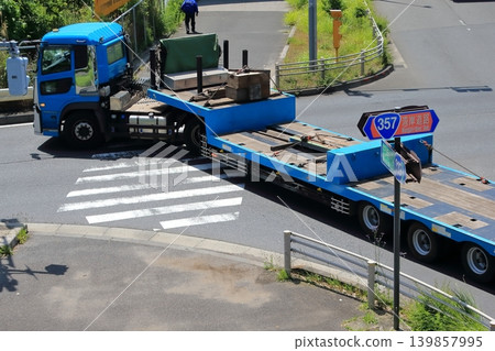 一輛拖車在十字路口左轉。 一輛拖車在十字路口左轉。 139857995