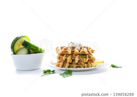 vegetable waffles with zucchini and creamy herb sauce on plate vegetable waffles with zucchini and creamy herb sauce on plate 139858289