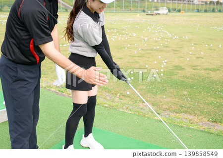 Japanese woman taking golf lessons Japanese woman taking golf lessons 139858549
