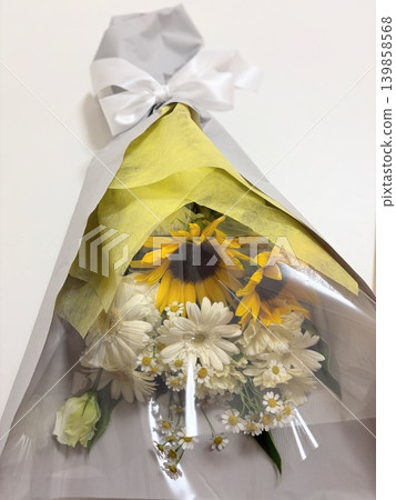 Sunflower and white flower bouquet with white ribbon Sunflower and white flower bouquet with white ribbon 139858568