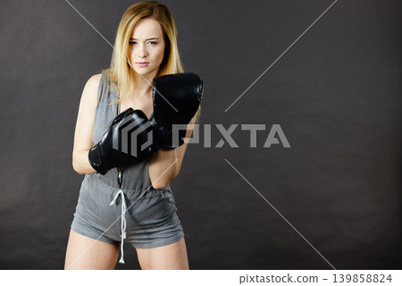 Boxer girl exercise with boxing gloves. Boxer girl exercise with boxing gloves. 139858824