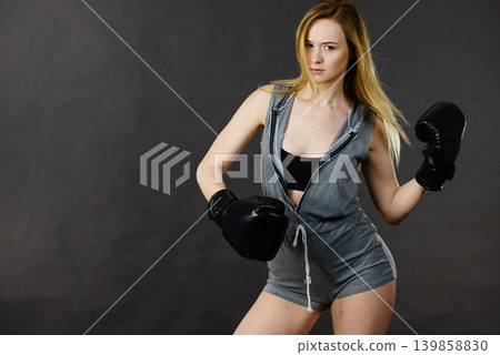 Boxer girl exercise with boxing gloves. 139858830