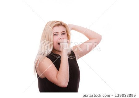 Portrait of adult blonde woman yawning Portrait of adult blonde woman yawning 139858899