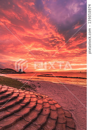 A dramatic sunset scene that dyed the sea around Tanegashima Island a reddish-purple. A dramatic sunset scene that dyed the sea around Tanegashima Island a reddish-purple. 139858974