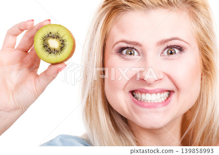 Woman holding green kiwi fruit Woman holding green kiwi fruit 139858993