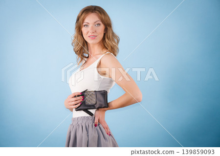 Elegant woman holding hand purse wallet Elegant woman holding hand purse wallet 139859093