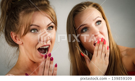 Two shocked teen women gossiping Two shocked teen women gossiping 139859109
