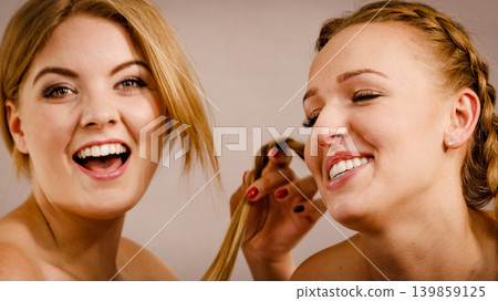 Woman showing her best friend braid 139859125