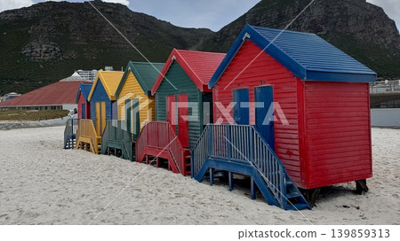 A seaside landscape with five colorful huts lined up. 139859313
