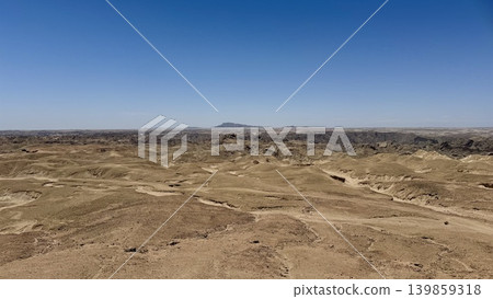 A desert landscape stretching out like the surface of the moon. A desert landscape stretching out like the surface of the moon. 139859318