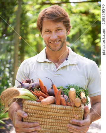 Man, portrait and basket for vegetables harvest for small business or agriculture, production or sustainability. Male person, face and carrots or beetroot forr eco farming career, gardening or diet Man, portrait and basket for vegetables harvest for small business or agriculture, production or sustainability. Male person, face and carrots or beetroot forr eco farming career, gardening or diet 139859579