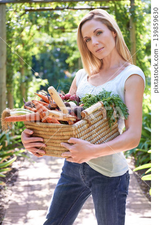 Woman, portrait and basket for vegetables harvest for small business or agriculture, production or sustainability. Female person, face and carrots or beetroot or eco farming career, organic or diet Woman, portrait and basket for vegetables harvest for small business or agriculture, production or sustainability. Female person, face and carrots or beetroot or eco farming career, organic or diet 139859630