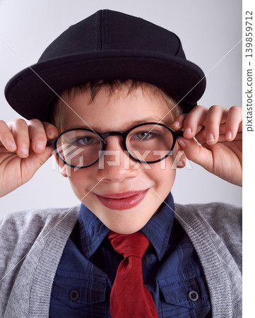 Glasses, smile and portrait of child in studio for eye care, vision and optical health. Happy, optometry and cute young boy kid with stylish eyewear or spectacles isolated by gray background. Glasses, smile and portrait of child in studio for eye care, vision and optical health. Happy, optometry and cute young boy kid with stylish eyewear or spectacles isolated by gray background. 139859712