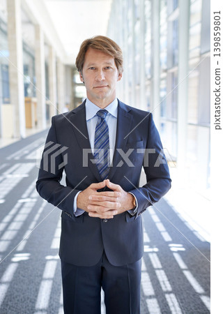 Serious, office and portrait of business man in hallway for growth, pride and confident mindset for company. Corporate manager, professional and person in workplace for career, job and opportunity Serious, office and portrait of business man in hallway for growth, pride and confident mindset for company. Corporate manager, professional and person in workplace for career, job and opportunity 139859801