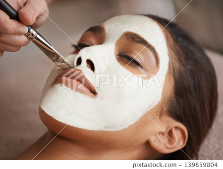 Skincare, brush and woman with face mask at spa for glow, wellness and beauty routine with self care. Cosmetic, natural and female person relaxing for clay facial dermatology treatment at salon. Skincare, brush and woman with face mask at spa for glow, wellness and beauty routine with self care. Cosmetic, natural and female person relaxing for clay facial dermatology treatment at salon. 139859804