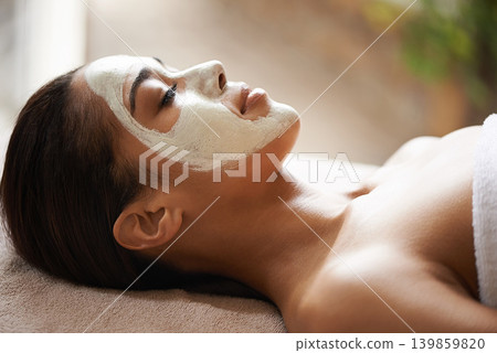 Skincare, wellness and woman with face mask at spa for glow, natural and beauty routine with peace. Cosmetic, pamper and female person relaxing for clay facial dermatology treatment at salon. Skincare, wellness and woman with face mask at spa for glow, natural and beauty routine with peace. Cosmetic, pamper and female person relaxing for clay facial dermatology treatment at salon. 139859820