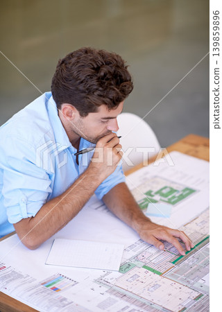 Architecture, brainstorming and man in office with blueprint, thinking and reading paper for renovation. Designer, engineer or creative developer at desk with floor plan or remodeling with high angle Architecture, brainstorming and man in office with blueprint, thinking and reading paper for renovation. Designer, engineer or creative developer at desk with floor plan or remodeling with high angle 139859896