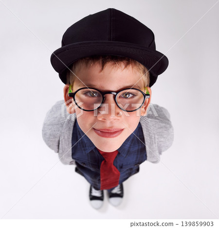 Glasses, happy and portrait of child in studio for eye care, vision and optical health. Smile, optometry and top view of young boy kid with stylish eyewear or spectacles isolated by gray background. 139859903