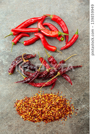 Red hot chili peppers on a stone background. Red hot chili peppers on a stone background. 139859949