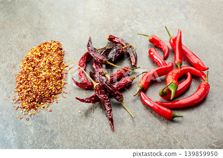 Red hot chili peppers on a stone background. Red hot chili peppers on a stone background. 139859950