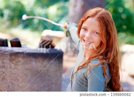 Girl, smile and portrait by fire with marshmallow for camping adventure, summer and vacation for fun outdoors. Child, happy and face by barbecue with stick on holiday, outside and freedom to relax Girl, smile and portrait by fire with marshmallow for camping adventure, summer and vacation for fun outdoors. Child, happy and face by barbecue with stick on holiday, outside and freedom to relax 139860082