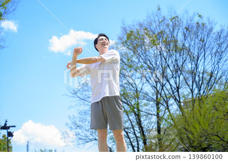 Japanese man stretching in sportswear Japanese man stretching in sportswear 139860100